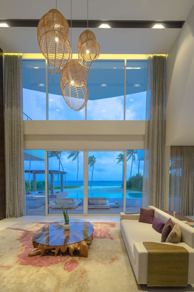 Elegant modern living room with ocean view, featuring luxury decor and lighting.